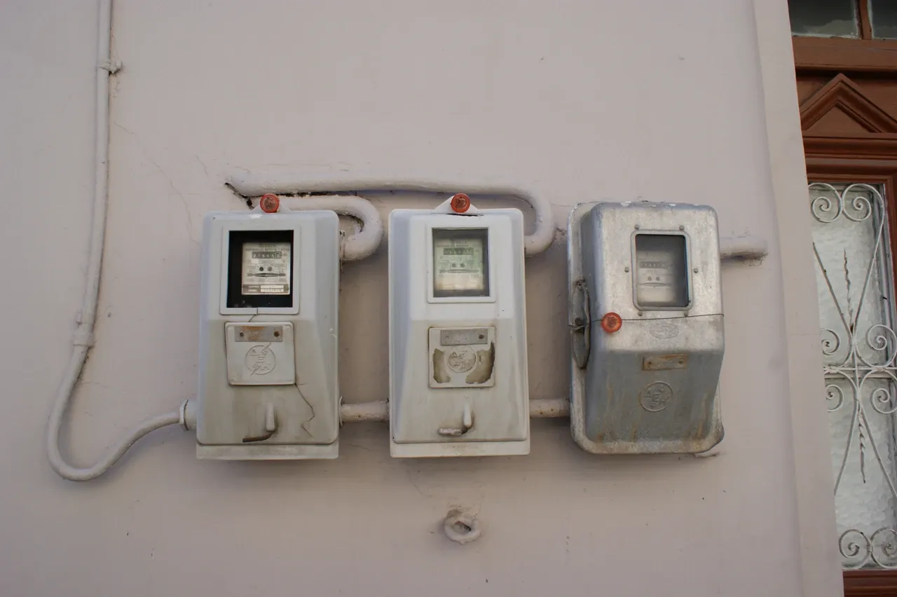Three electricity meters on the outside wall of a house in Kos, Greece, photographed in December 2019
