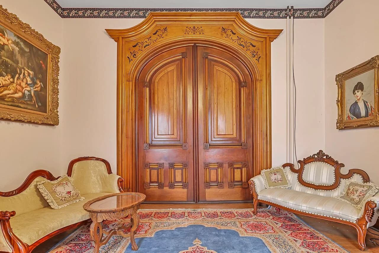 Second living-room view with closed wooden doors in the Samuel N. Patterson House, September 2022