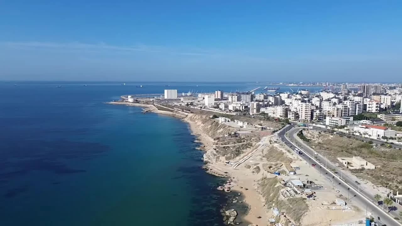 Aerial view of Latakia’s Southern Corniche, with the Mediterranean coast and city buildings, filmed in November 2025